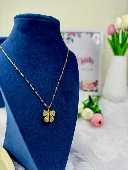 Gold-tone necklace with a bow-shaped pendant