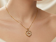 Gold-tone necklace with a caged heart-shaped pendant