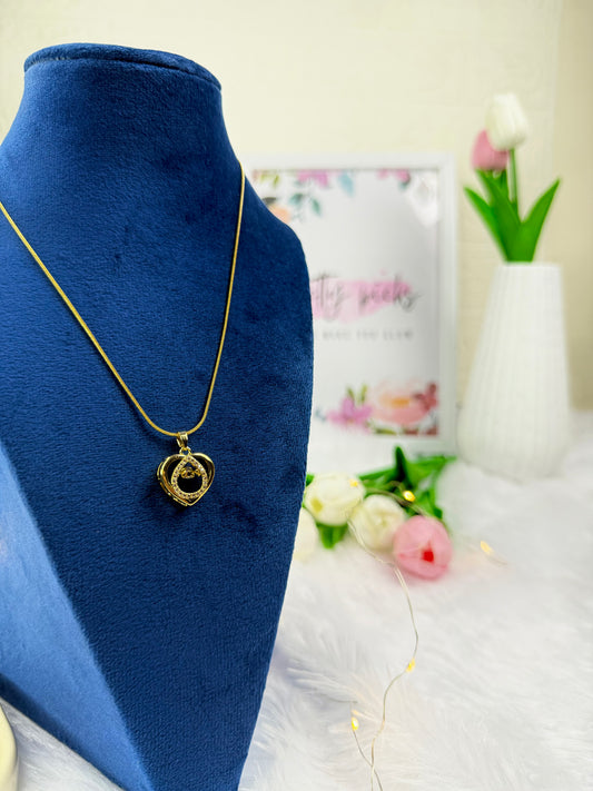 Gold-tone necklace with a caged heart-shaped pendant