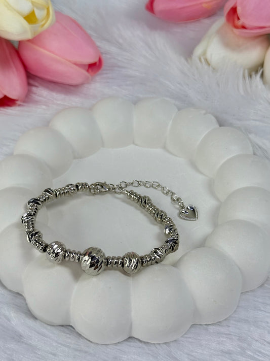 beaded bracelet with an adjustable chain and a small heart charm.