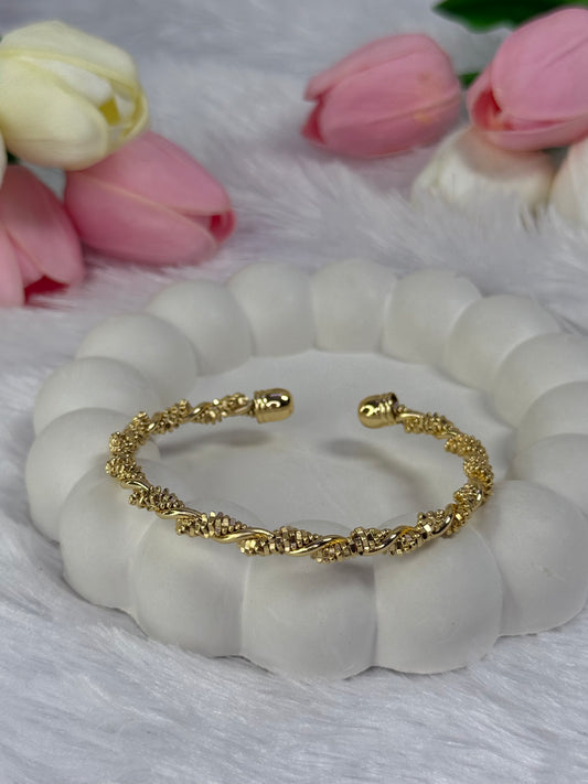 Gold-colored twisted open cuff bracelet